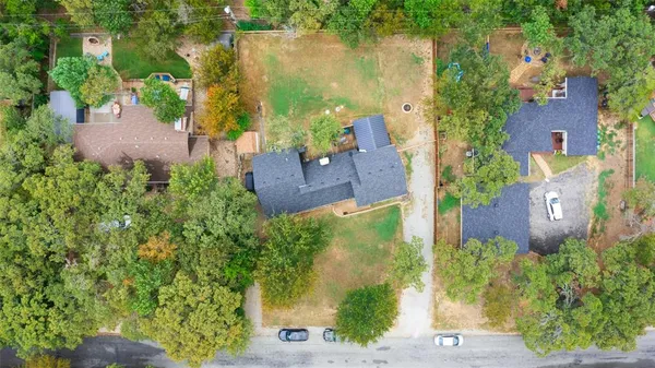 an aerial view of a house with a yard basket ball court and outdoor seating