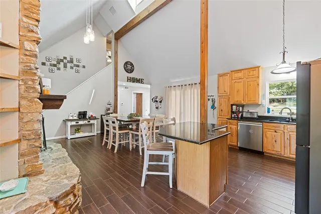 a view of a kitchen with furniture and wooden floor