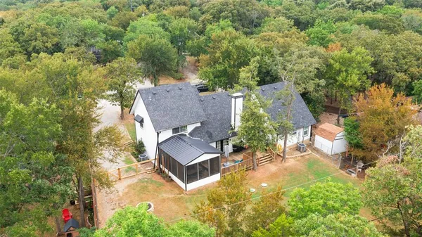 an aerial view of a house with yard swimming pool and outdoor seating