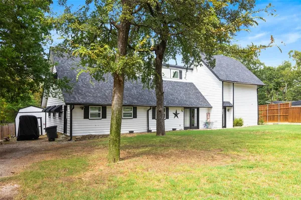 a house that has a tree in front of it