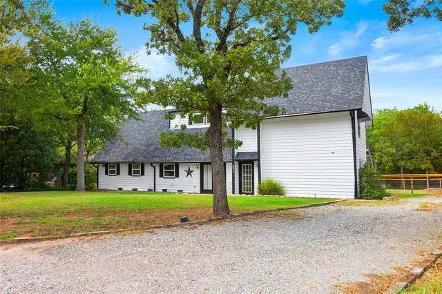a front view of house with yard and green space