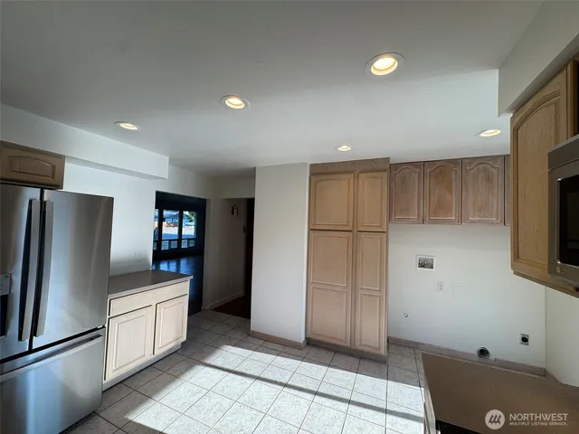 a kitchen with a refrigerator and a sink