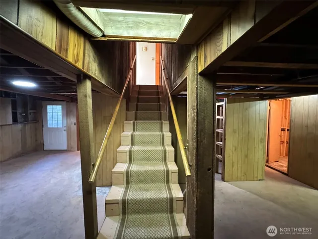 a kitchen with a chandelier a sink and cabinets