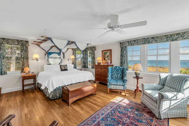 a bedroom with a bed and a lamp next to a window