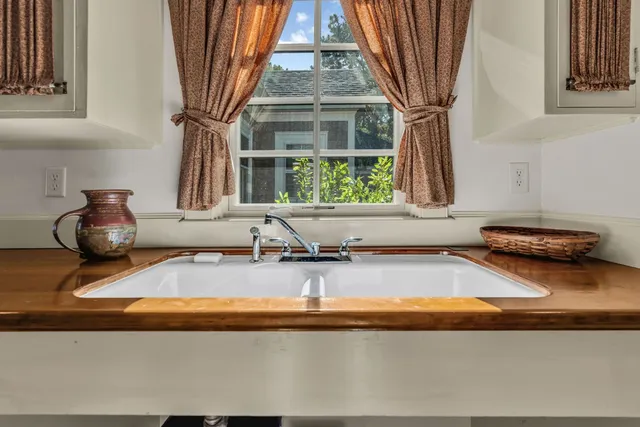 a view of a dining room with furniture large windows and wooden floor