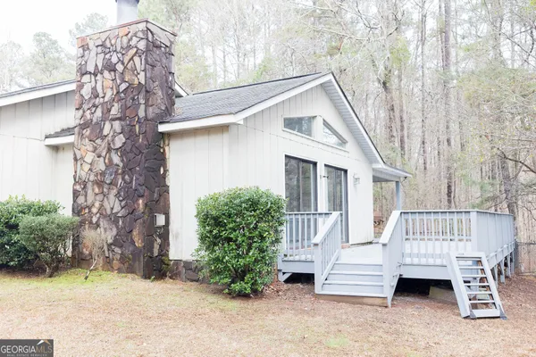 a view of a house with a yard and sitting area
