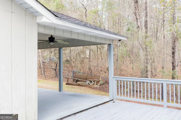a view of a porch with a table and chairs
