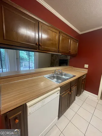a kitchen that has a sink and a stove
