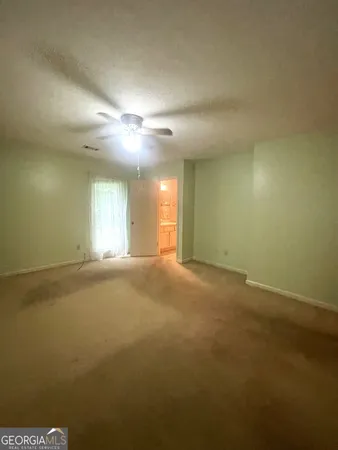 a view of a hallway with wooden floor and closet