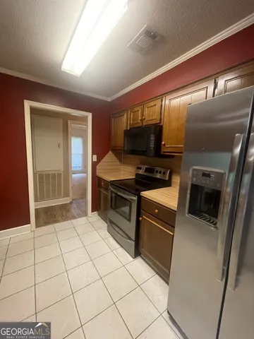 a kitchen with stainless steel appliances a stove a sink and a microwave