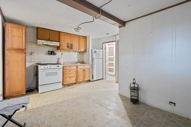 a kitchen with stainless steel appliances a refrigerator and a stove top oven