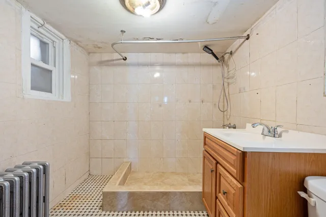 a bathroom with a sink a mirror and shower