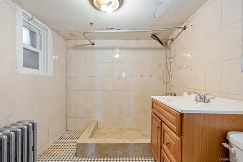 a bathroom with a sink a mirror and shower