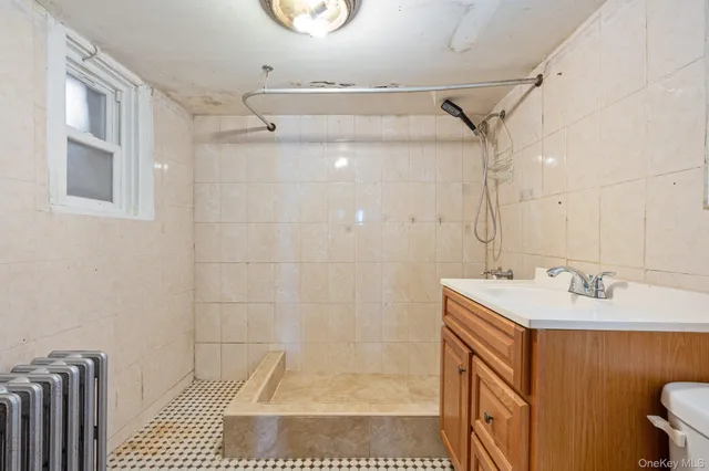 a bathroom with a sink a mirror and shower