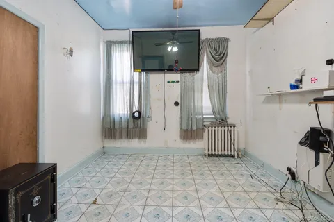 a view of a livingroom with wooden floor and furniture