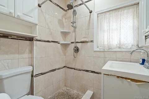 a bathroom with a shower toilet and sink