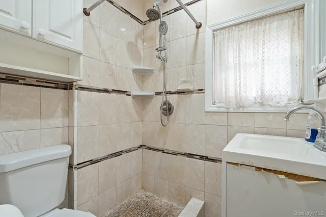 a bathroom with a shower toilet and sink