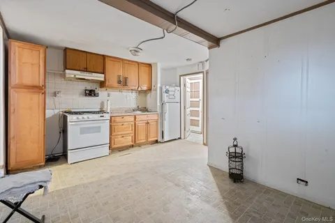 a kitchen with stainless steel appliances a refrigerator and a stove top oven