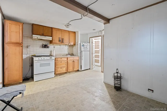 a kitchen with stainless steel appliances a refrigerator and a stove top oven