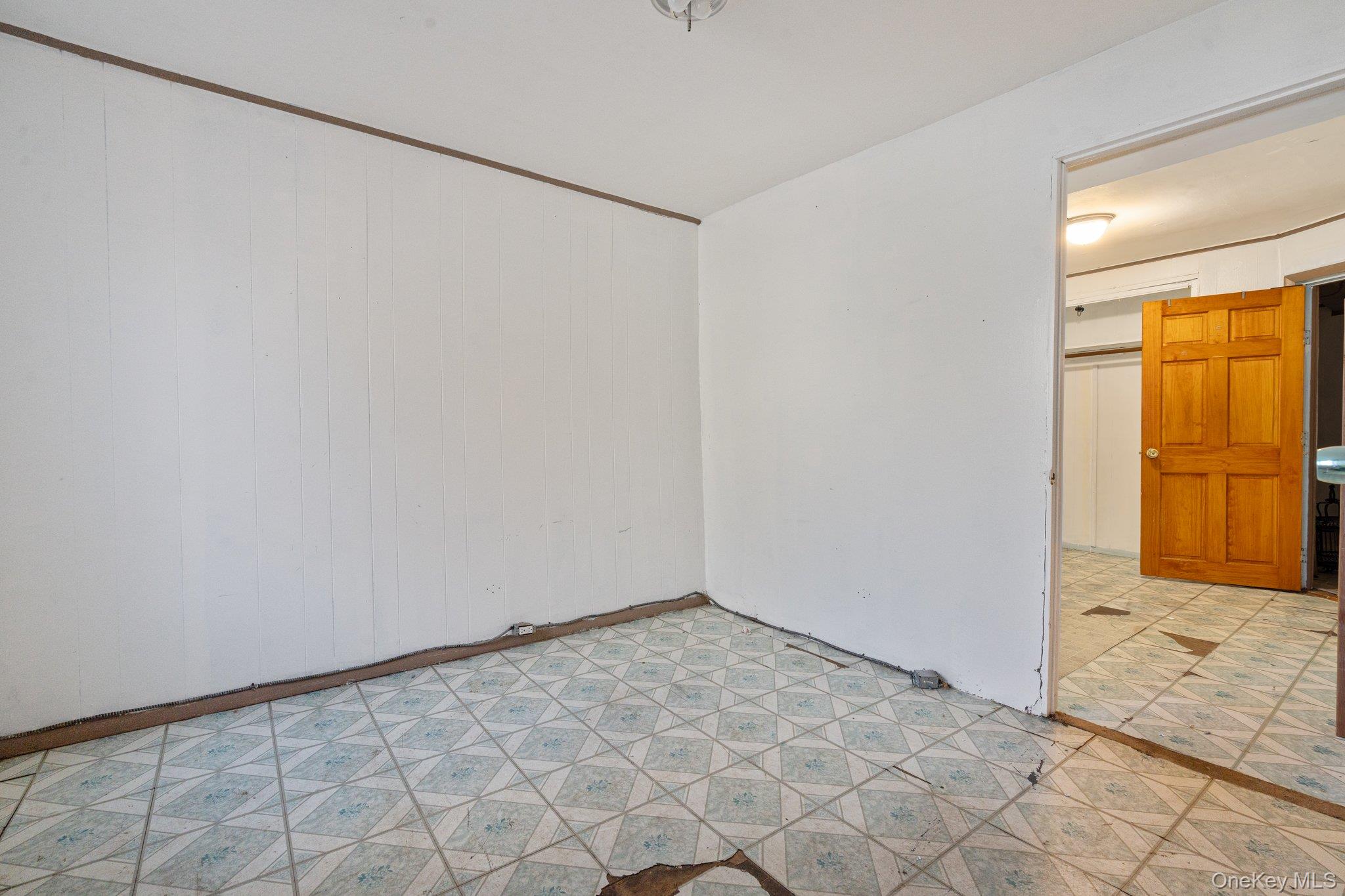 100-30 Martense Avenue Queens, NY 11368 - Photo 7 of 36 Empty room with light floors