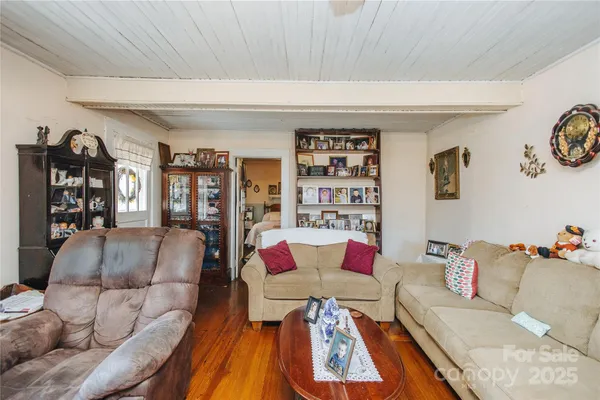 a living room with furniture and book shelf