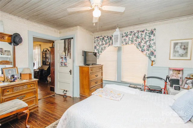 a bedroom with a bed and a chandelier