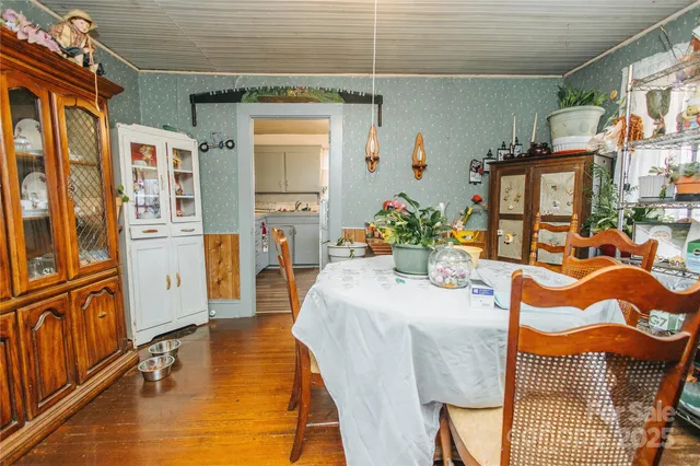 a dining room with stainless steel appliances kitchen island granite countertop a table and chairs