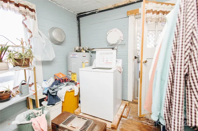 a living room with a dining table and a window with garden view