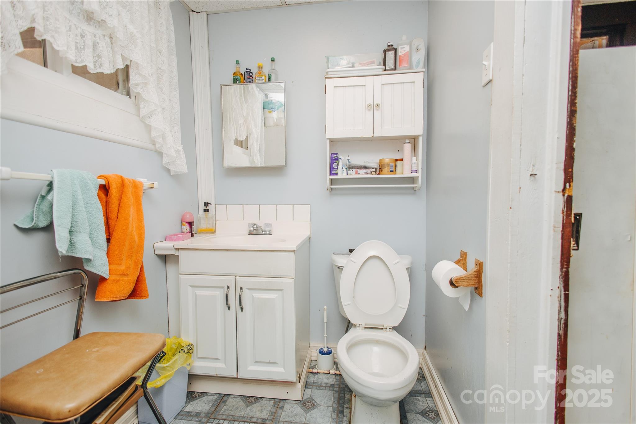 63 Clear Creek Road Marion, NC 28752 - Photo 25 of 38 a bathroom with a sink toilet and painting on the wall