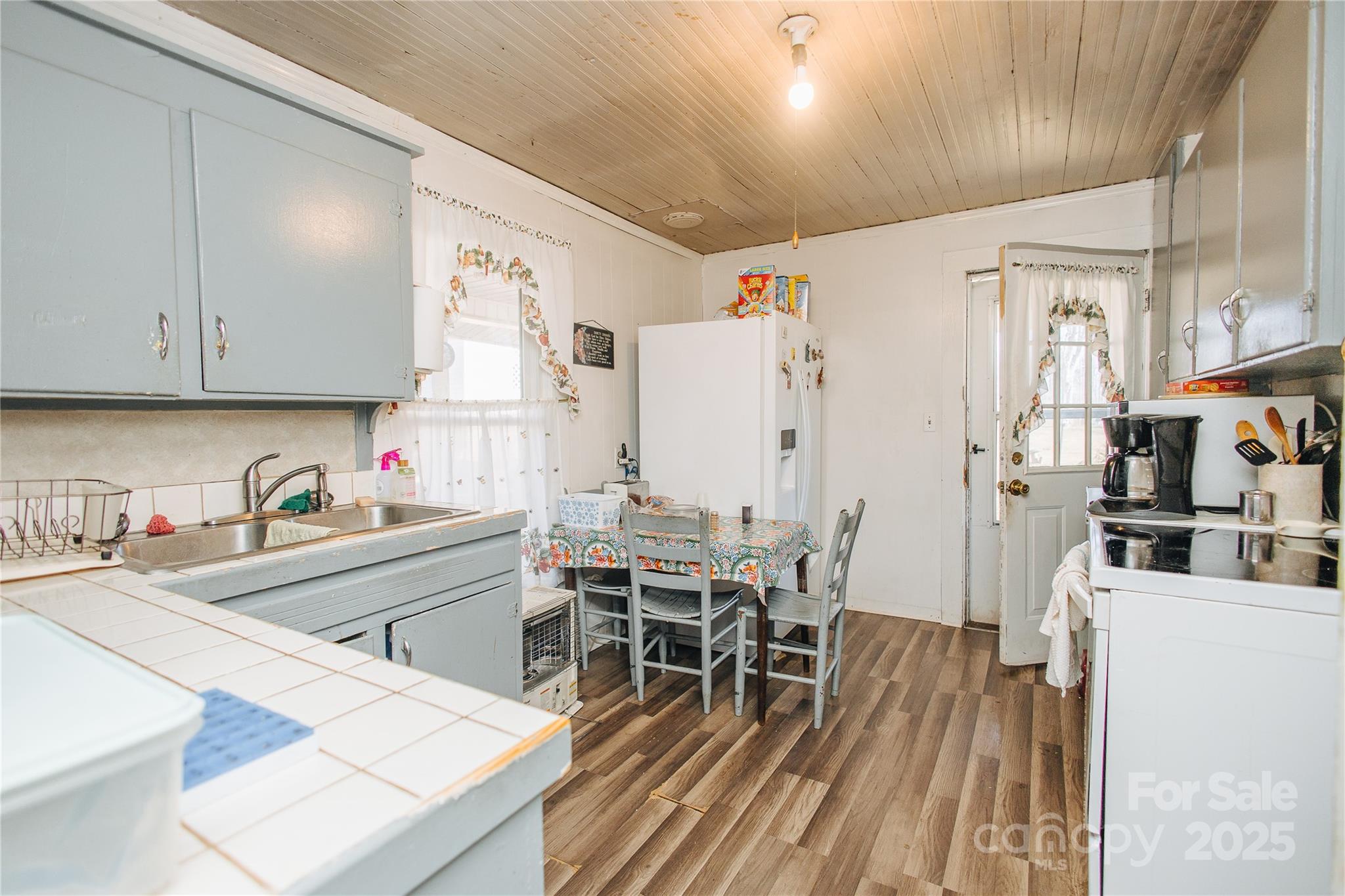 63 Clear Creek Road Marion, NC 28752 - Photo 26 of 38 a kitchen with stainless steel appliances wooden floor dining table and chairs