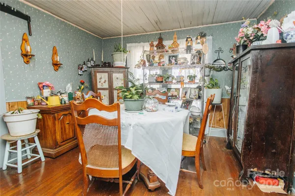 a outdoor dining space with furniture wooden floor and a chandelier