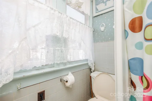a bathroom with a granite countertop sink mirror vanity and toilet