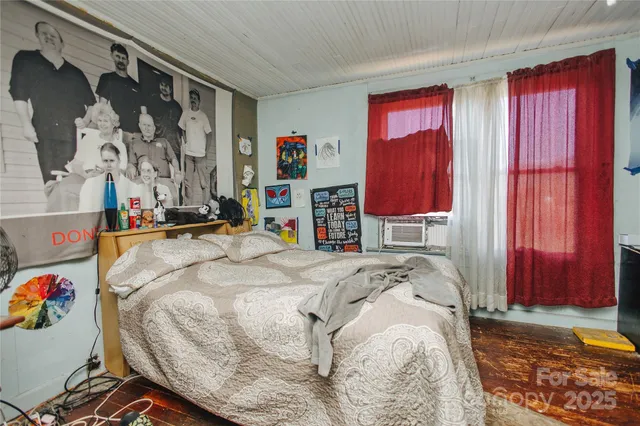 a bed sitting in a bedroom next to a window