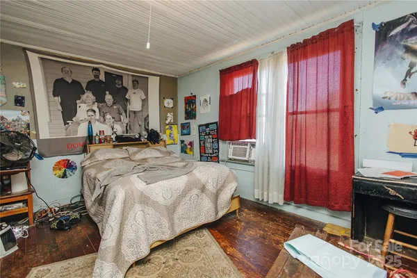 a bedroom with a bed and a mirror