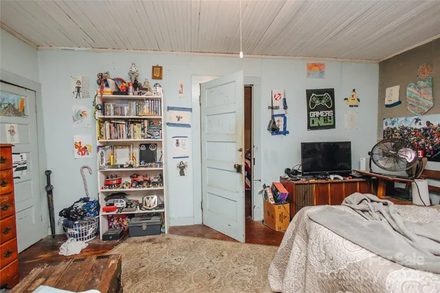 a bedroom with a bed and a book shelf