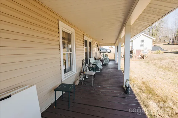a view of a porch with wooden floor