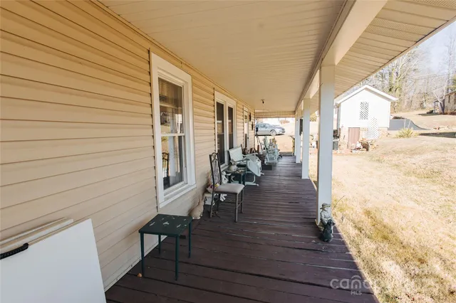 a view of a porch with wooden floor