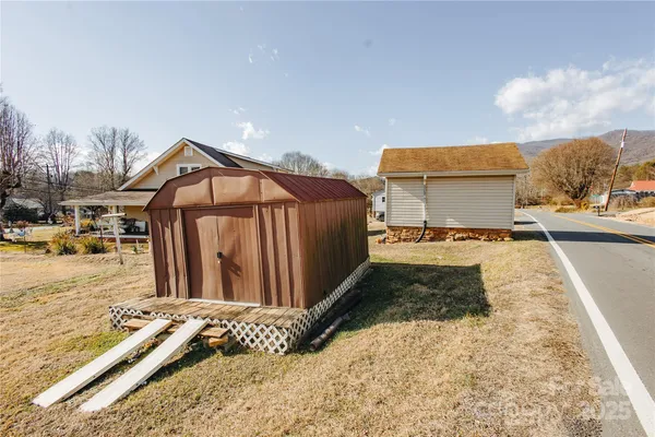 a view of a house with wooden fence