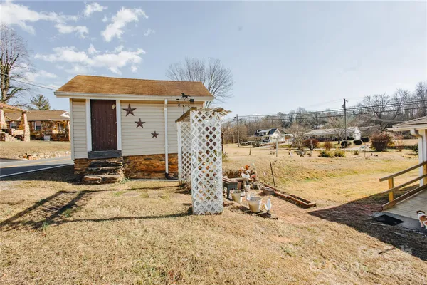 a view of a house with a snow on the road