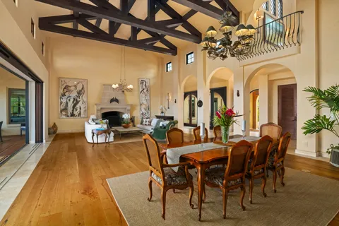 a view of a dining room with furniture and a chandelier