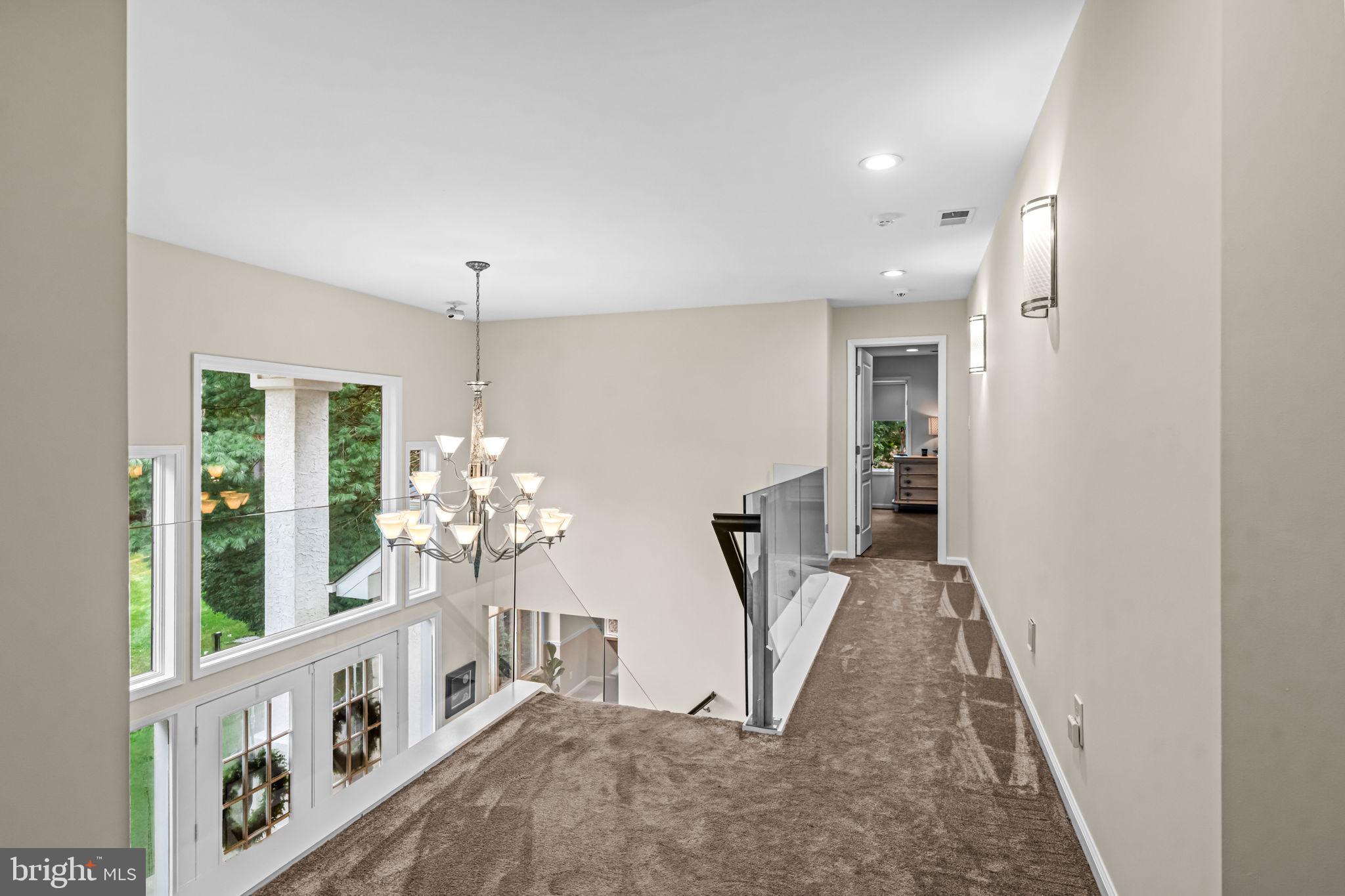73 Bortons Road Marlton, NJ 08053 - Photo 63 of 99 a view of a hallway to a livingroom with furniture wooden floor and windows