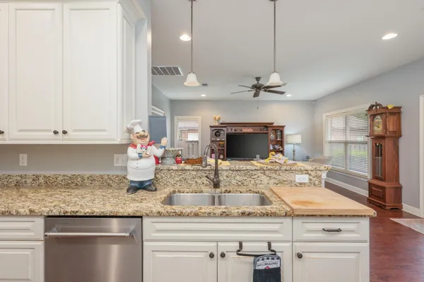 a kitchen with stainless steel appliances granite countertop a sink and cabinets
