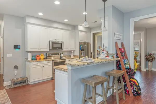a kitchen with a sink a stove and a refrigerator