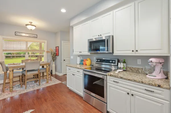 a kitchen with a stove a sink and a microwave