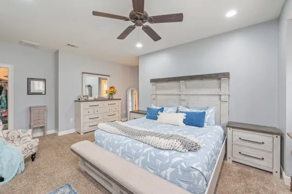 a bedroom with a bed and a chandelier