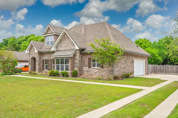 a front view of house with yard and green space