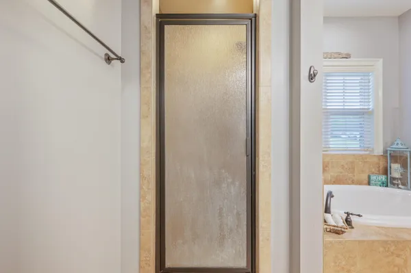 a bathroom with a bathtub and a shower