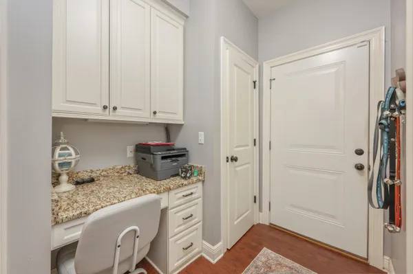 a kitchen with a refrigerator and cabinets