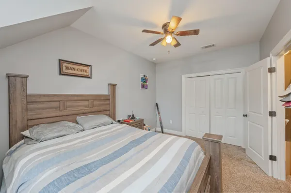 a bedroom with a bed and a chandelier