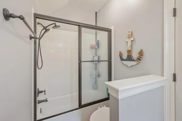 a bathroom with a shower and a mirror